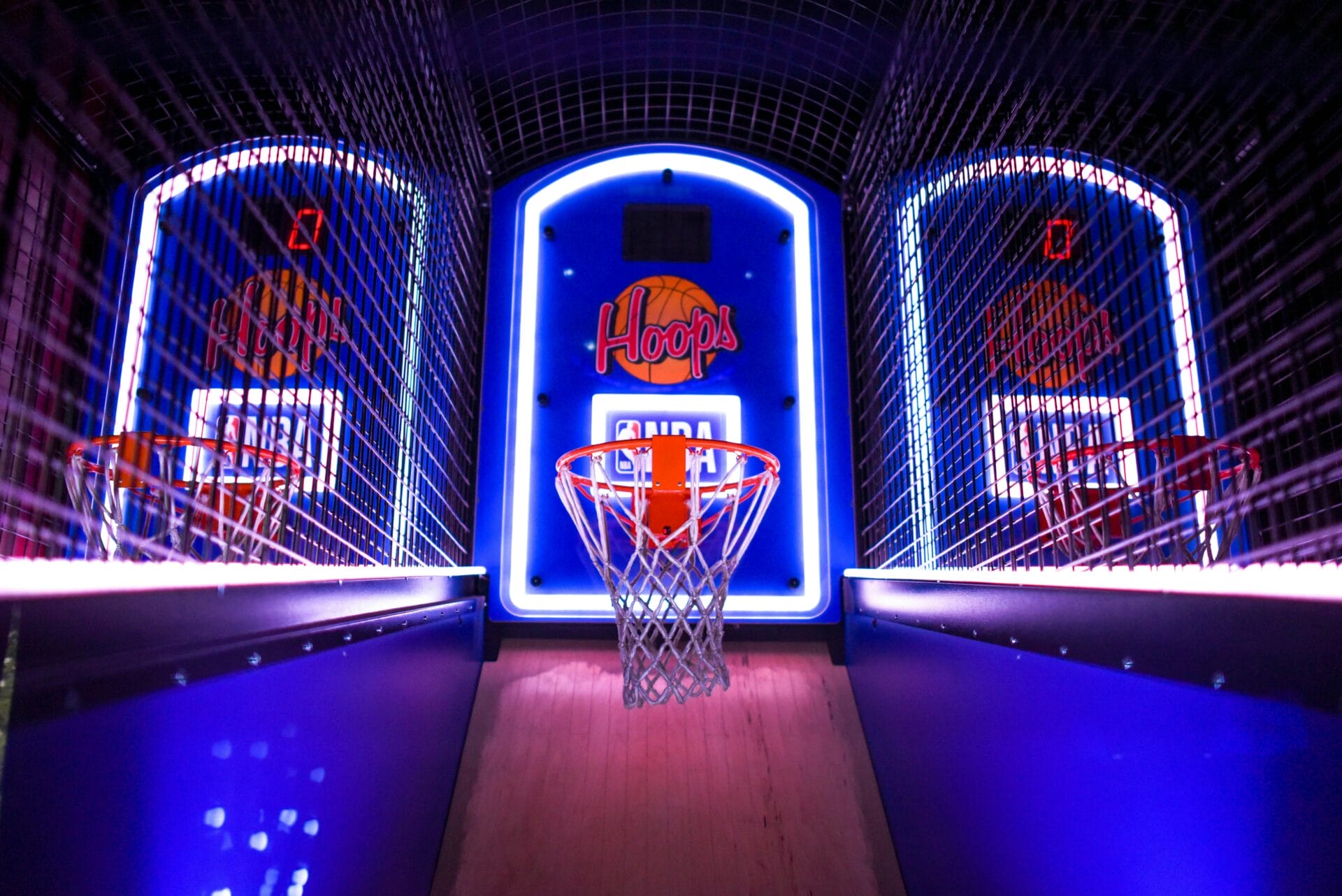 Indoor arcade with three electronic basketball hoops
