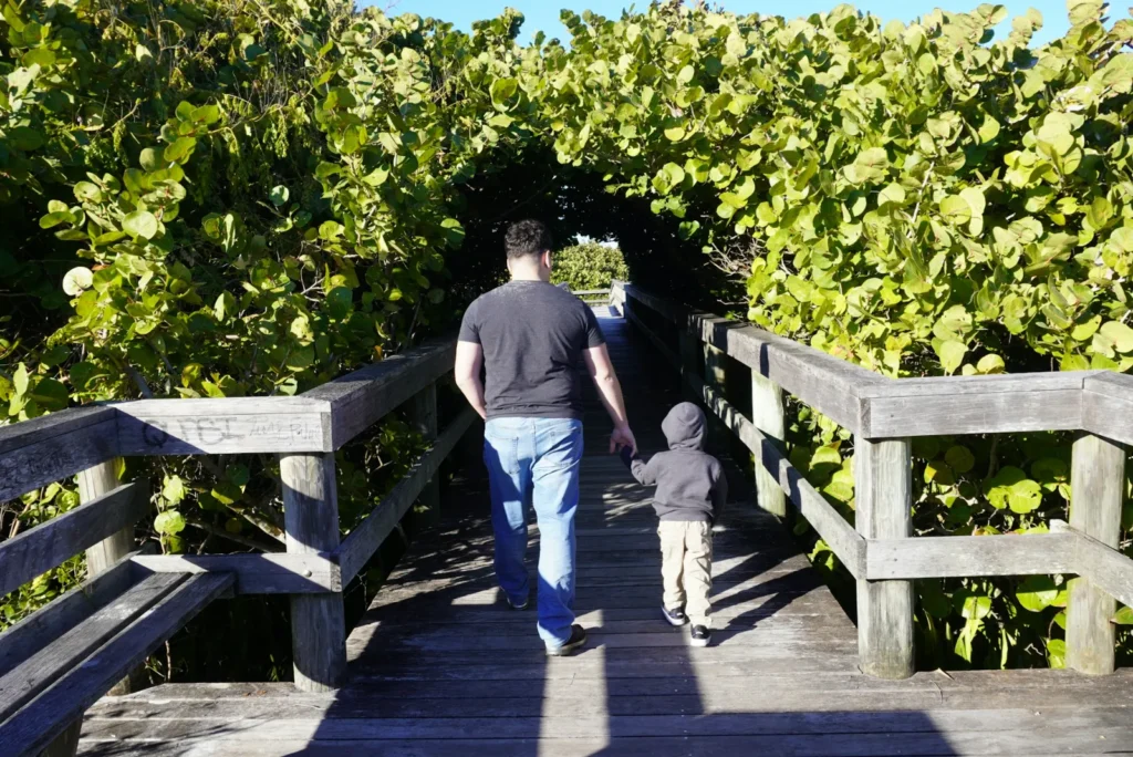 family at boardwalk at the beach